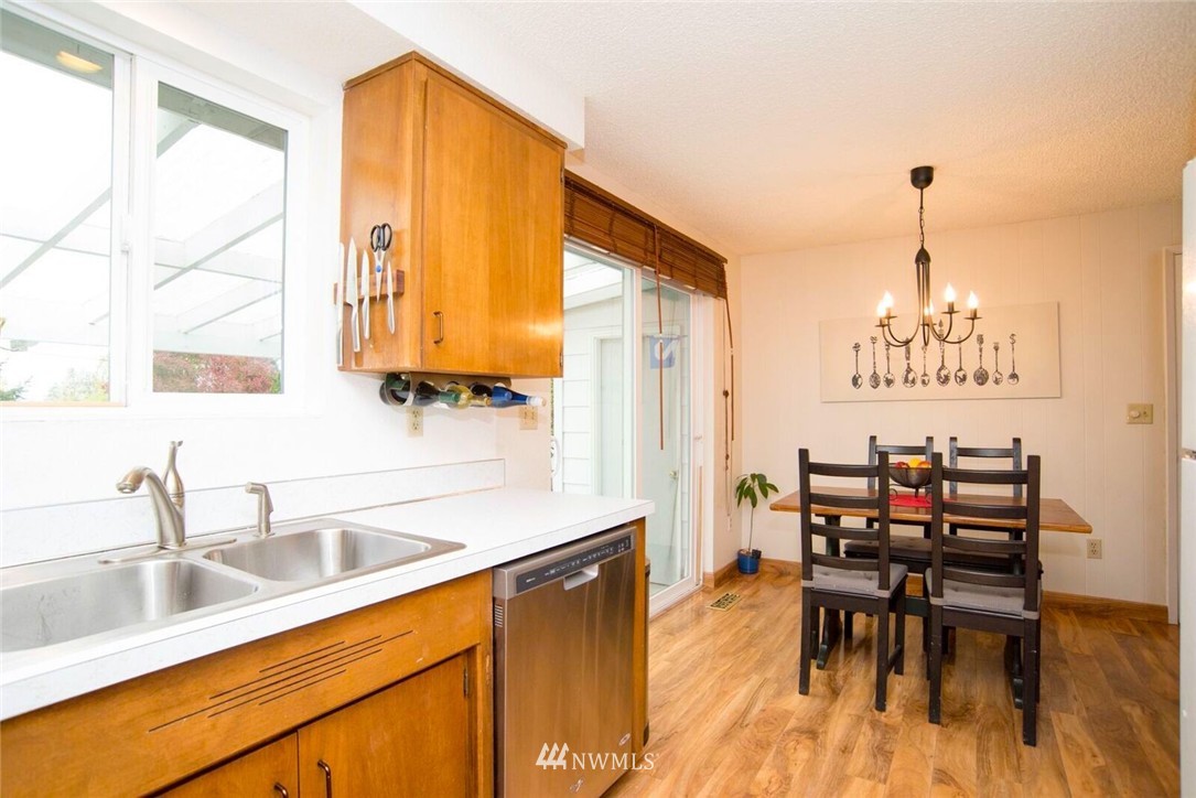 11510 Southeast 178th Place Renton, WA 98055 - Photo 8 of 18 a kitchen with a table chairs sink and cabinets