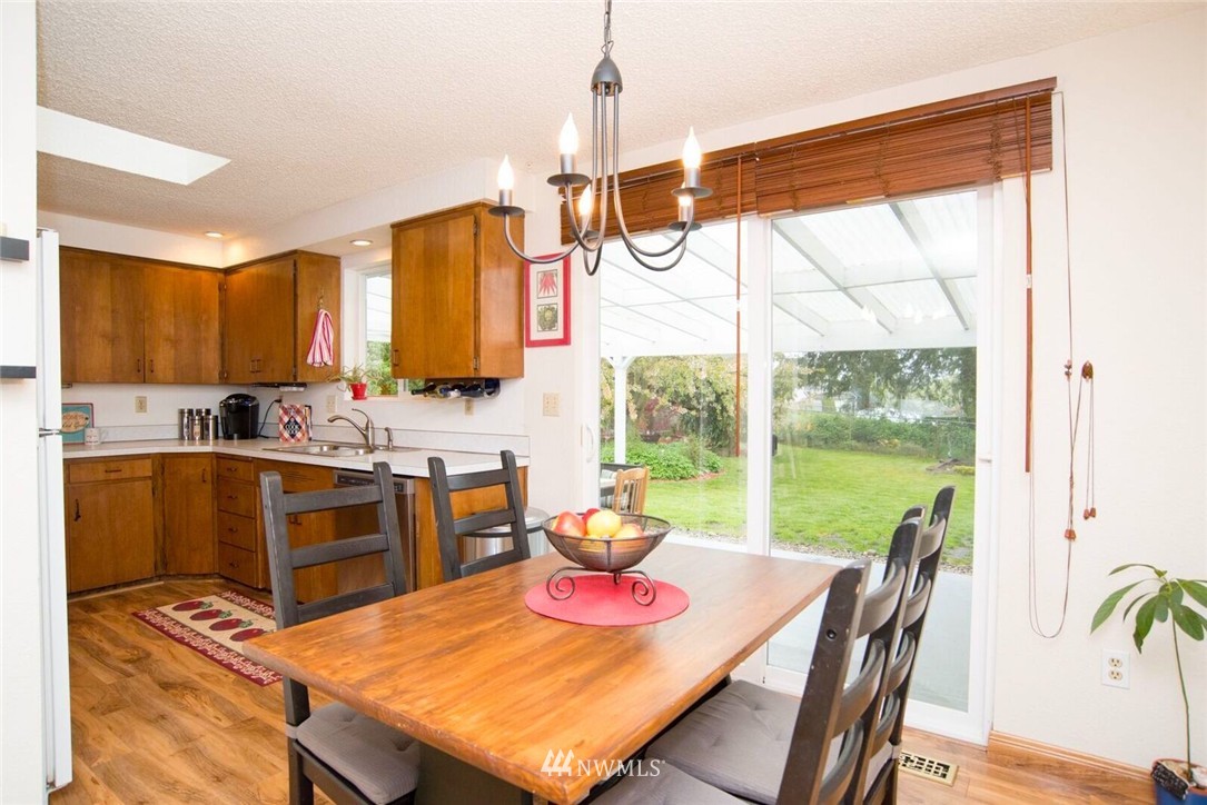 11510 Southeast 178th Place Renton, WA 98055 - Photo 10 of 18 a kitchen with a table chairs stove and sink