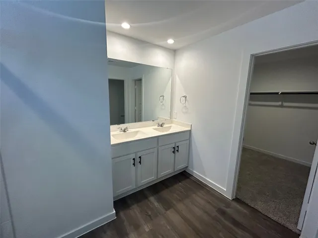 a bathroom with a double vanity sink and mirror