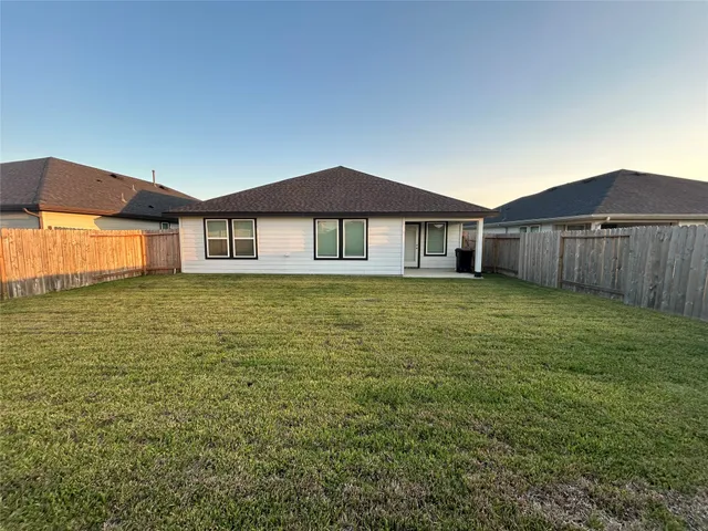 a large house with a big yard and large trees