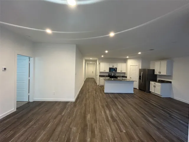 a view of kitchen with kitchen island microwave and stove
