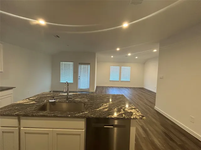 a kitchen with a sink and cabinets