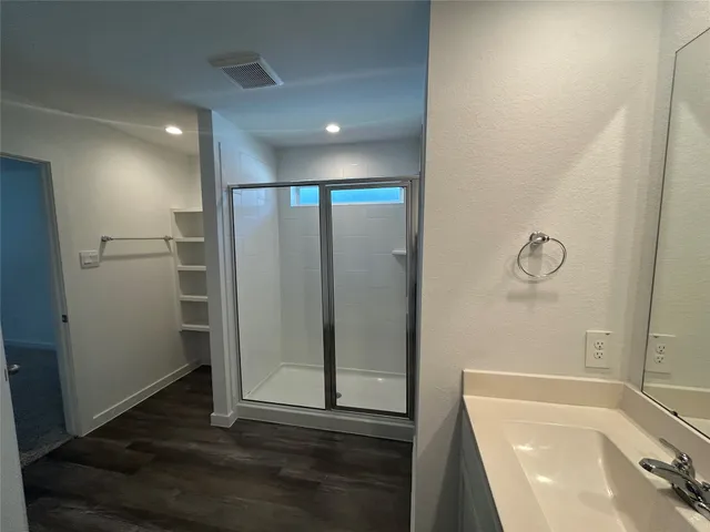 a bathroom with a bathtub and a shower