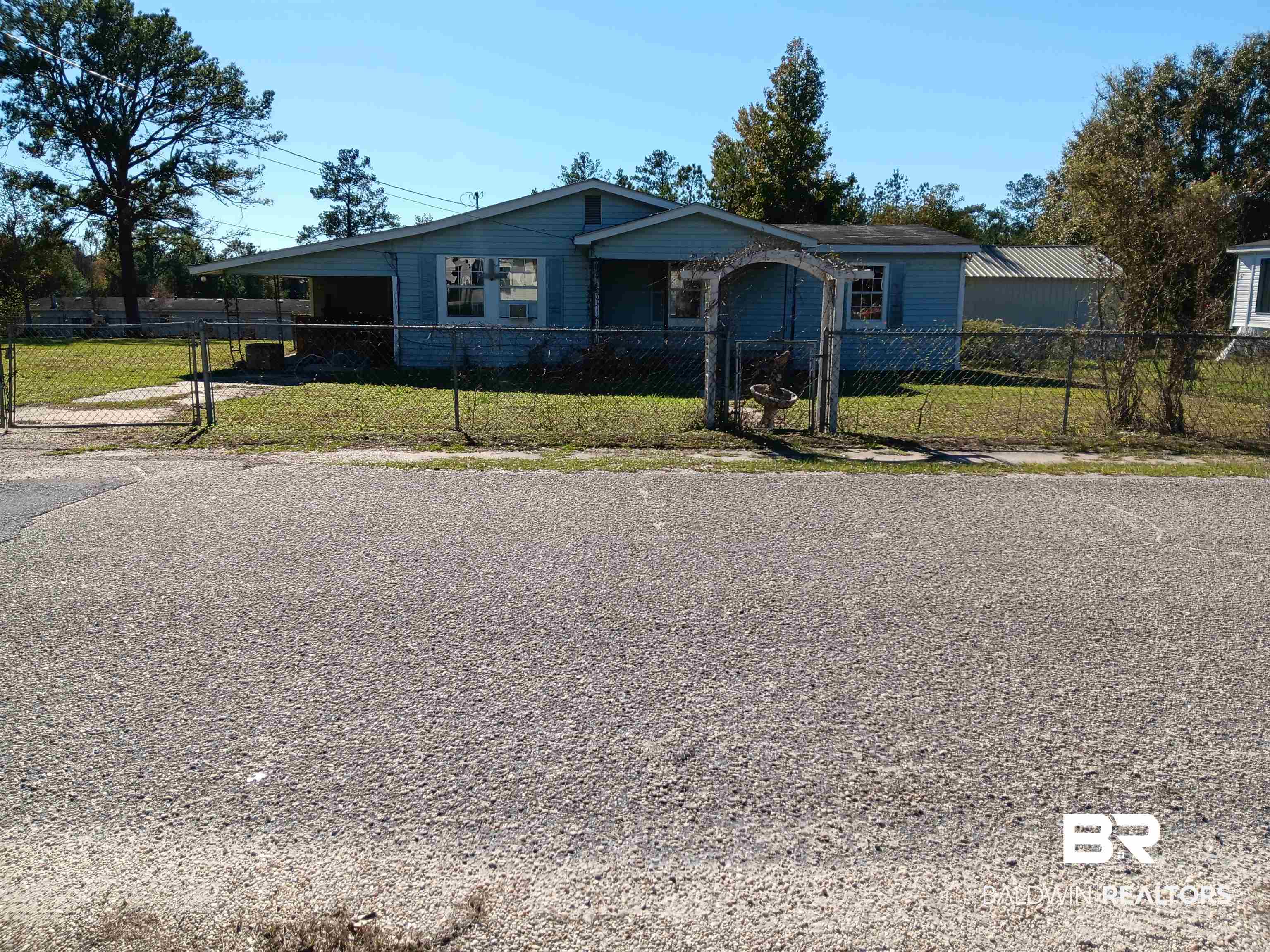 61 Katherine Street Flomaton, AL 36441 - Photo 1 of 13 View of front of property with a front lawn and a carport