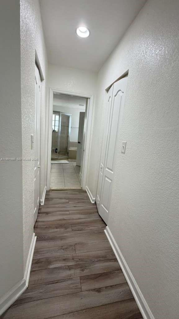14065 Southwest 278th Street Homestead, FL 33032 - Photo 20 of 30 a view of a hallway with wooden floor and a bathroom