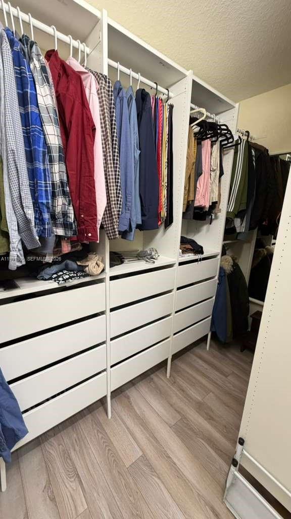 14065 Southwest 278th Street Homestead, FL 33032 - Photo 22 of 30 a view of walk in closet with clothes