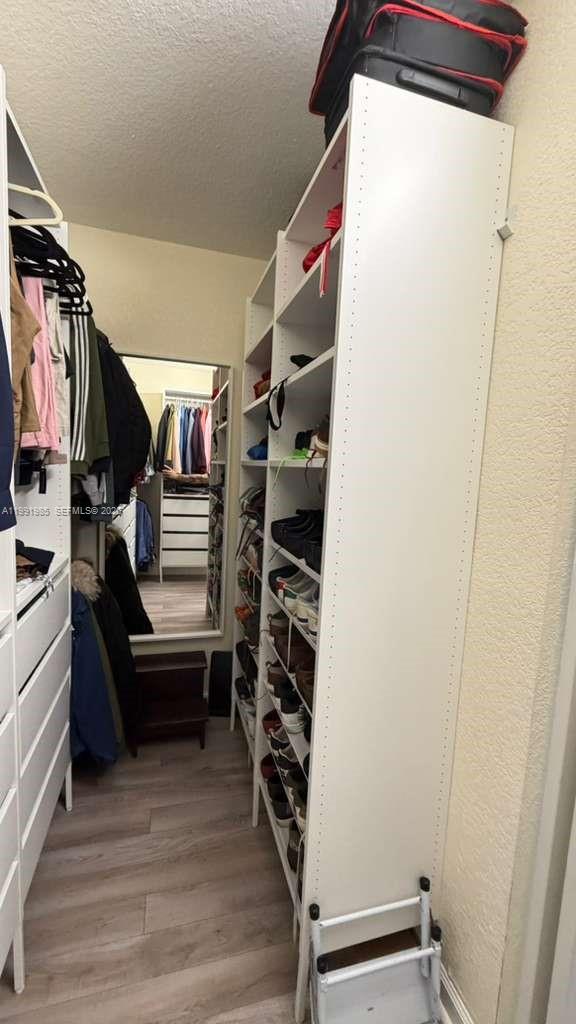 14065 Southwest 278th Street Homestead, FL 33032 - Photo 23 of 30 a view of walk in closet with clothes and shoes
