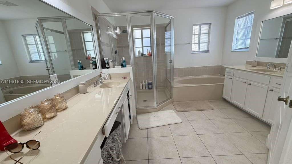 14065 Southwest 278th Street Homestead, FL 33032 - Photo 24 of 30 a spacious bathroom with a granite countertop tub sink and mirror