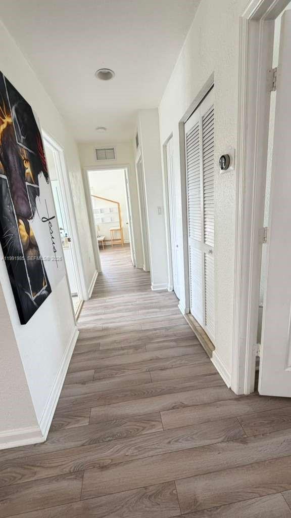 14065 Southwest 278th Street Homestead, FL 33032 - Photo 27 of 30 a view of a hallway with wooden floor and staircase