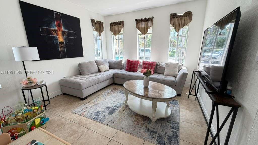 14065 Southwest 278th Street Homestead, FL 33032 - Photo 3 of 30 a living room with furniture and a flat screen tv