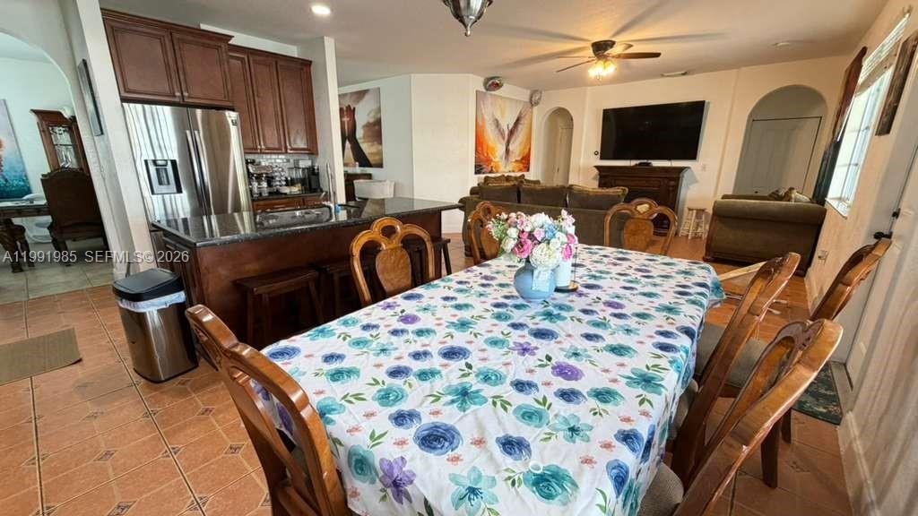 14065 Southwest 278th Street Homestead, FL 33032 - Photo 8 of 30 a living room with furniture a flat screen tv and a refrigerator