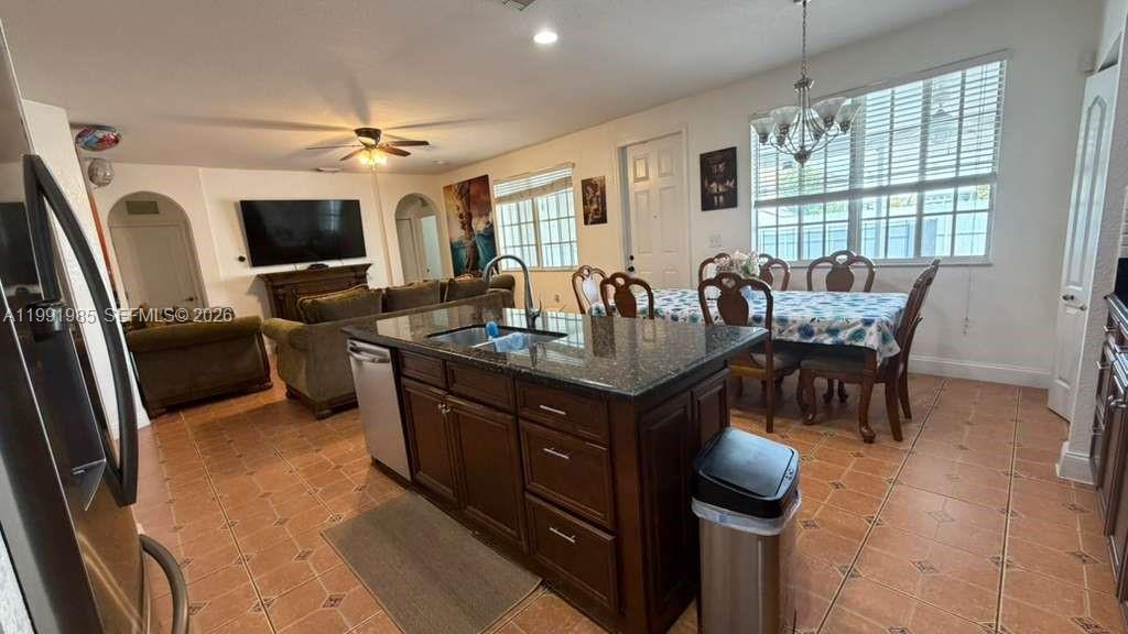 14065 Southwest 278th Street Homestead, FL 33032 - Photo 9 of 30 a dining hall with furniture a window and a kitchen view