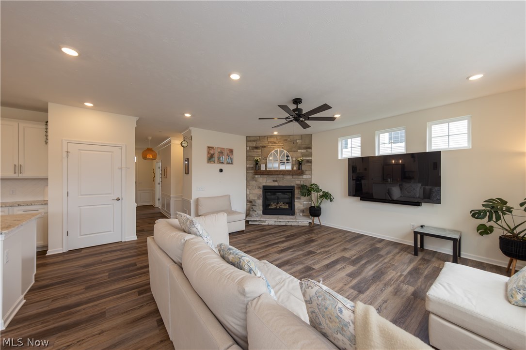 766 River Run Road Aurora, OH 44202 - Photo 11 of 49 Living area with a custom stone fireplace, ceiling fan, dark wood-type flooring, and recessed lighting
