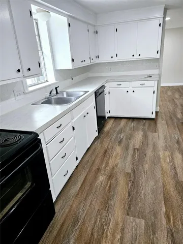 a view of kitchen with sink microwave and stove