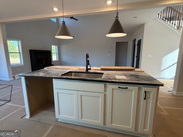 3083 W Highway Bowdon, GA 30108 - Photo 8 of 14 a kitchen with stainless steel appliances granite countertop a sink a stove and a wooden floors