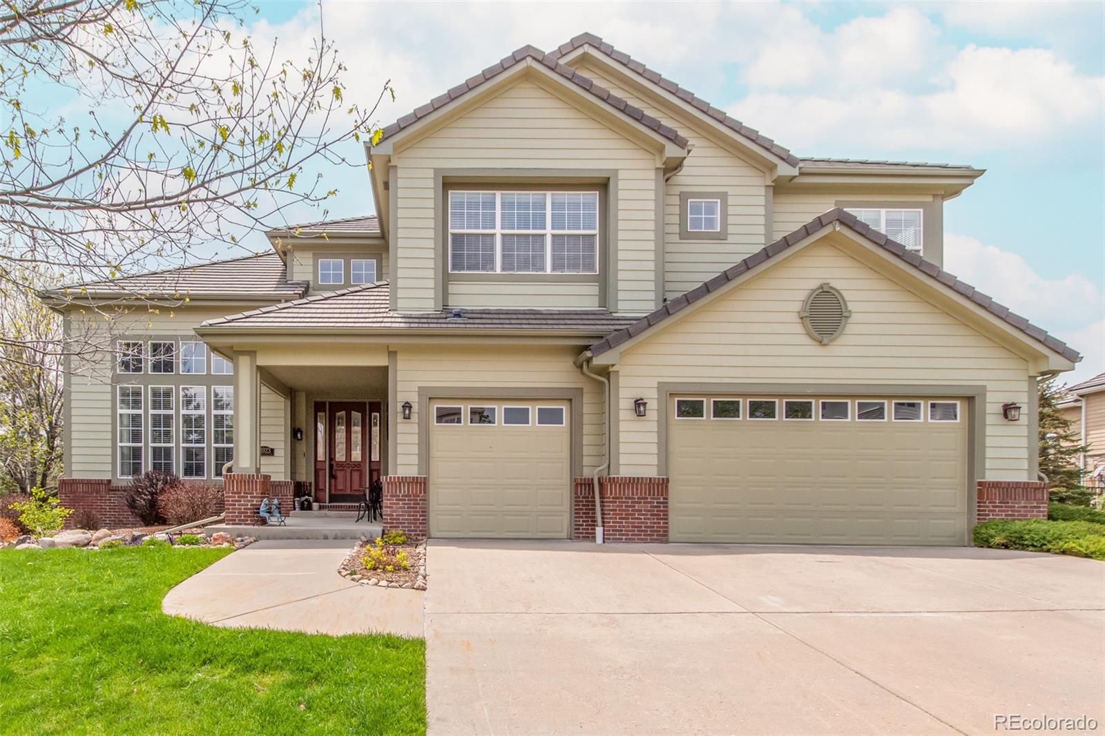 21923 East Ridge Trail Circle Aurora, CO 80016 - Photo 1 of 40 a front view of a house with garden
