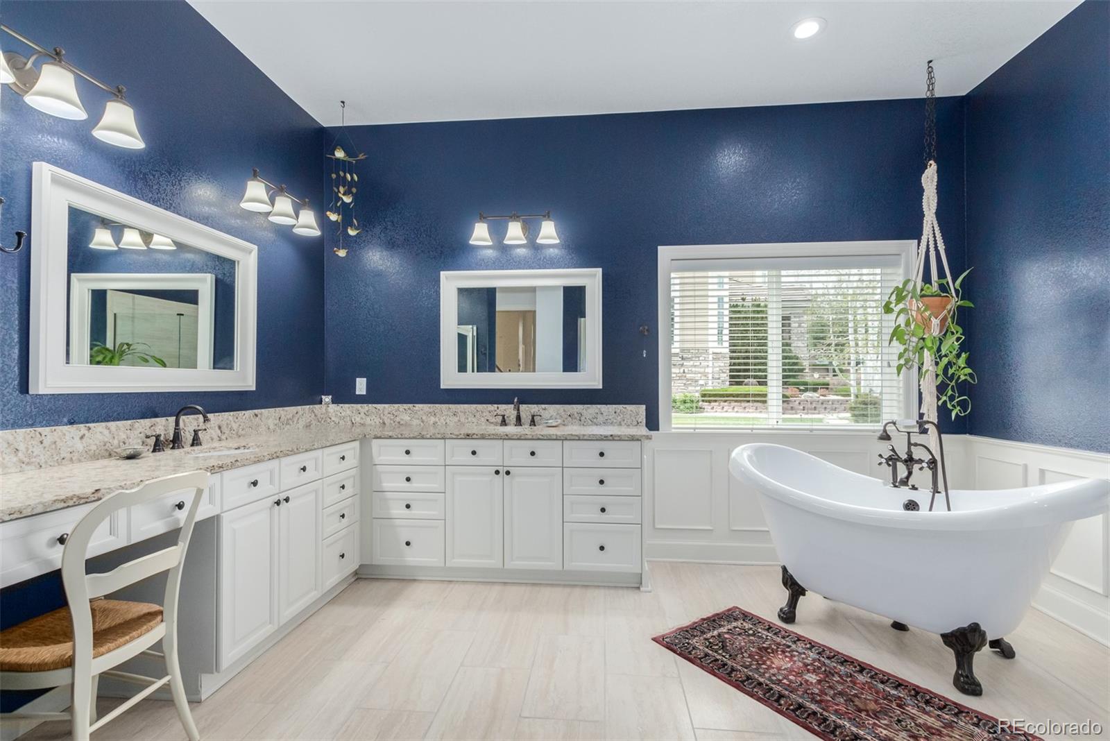 21923 East Ridge Trail Circle Aurora, CO 80016 - Photo 23 of 40 a spacious bathroom with a double vanity sink a large mirror and a bathtub