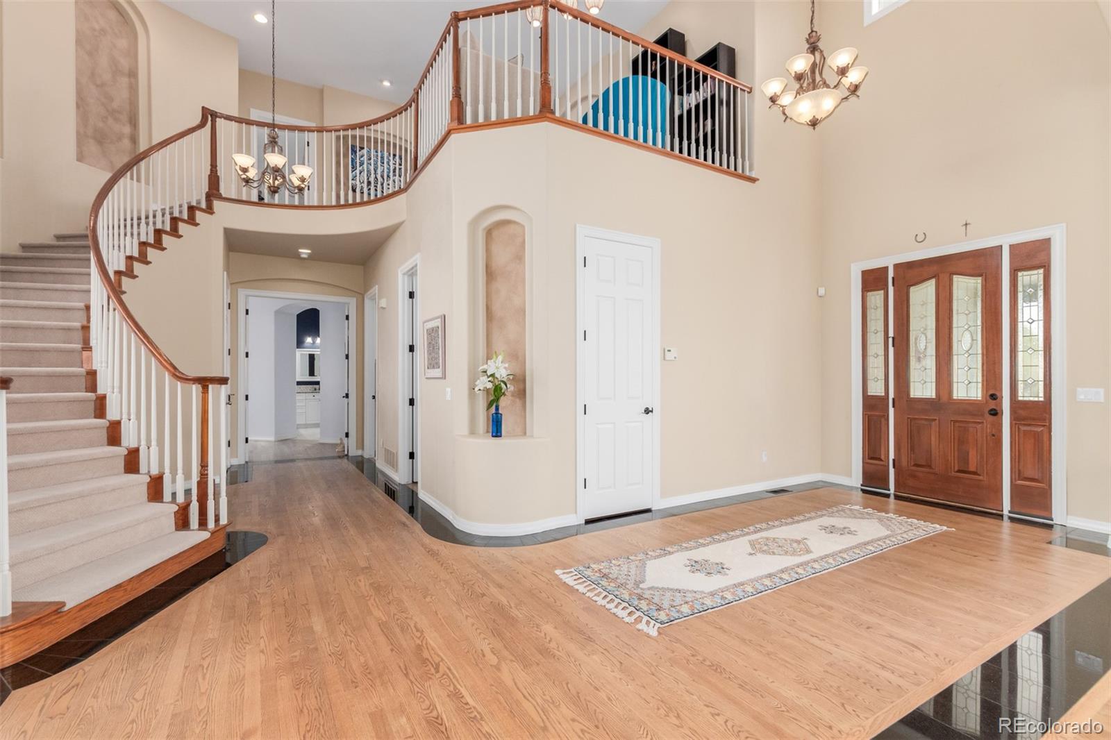 21923 East Ridge Trail Circle Aurora, CO 80016 - Photo 6 of 40 a view of a hallway with entryway wooden floor and front door