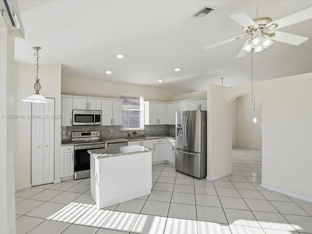 a kitchen with a refrigerator a sink and a stove