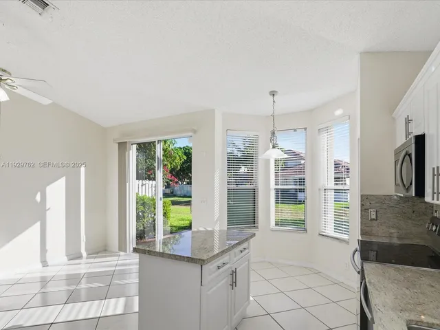 a view of a kitchen with a sink and a window