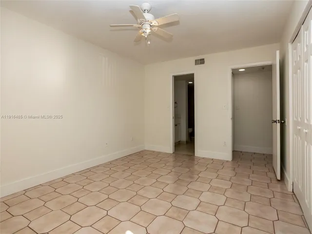 a view of bathroom with a sink mirror and window