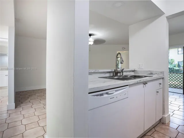a kitchen with a sink and refrigerator