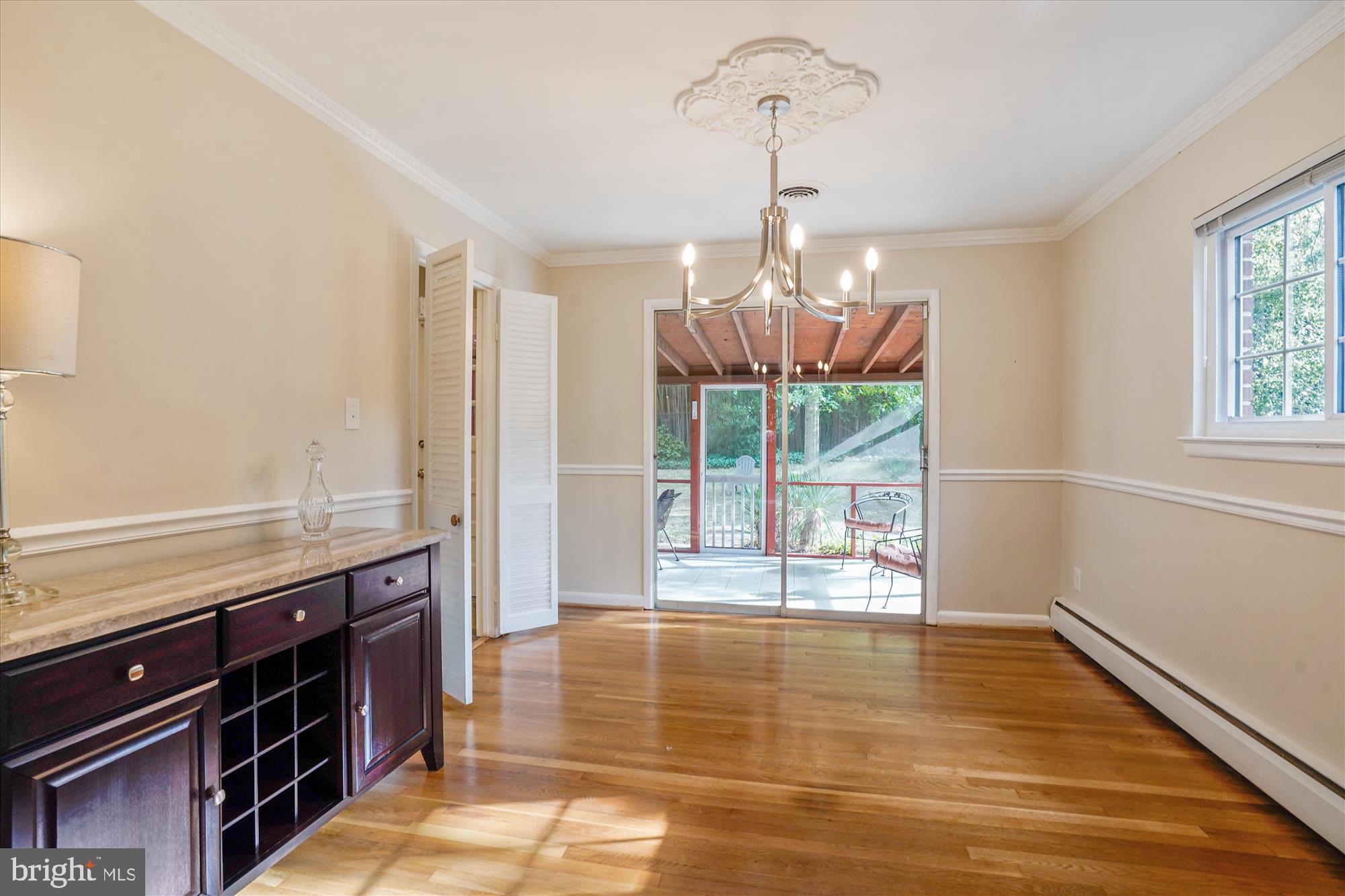 6216 Rockhurst Road Bethesda, MD 20817 - Photo 12 of 52 a view of a room with wooden floor and chandelier