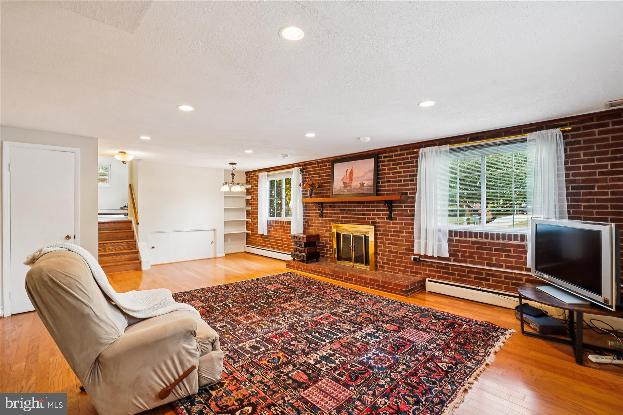 6216 Rockhurst Road Bethesda, MD 20817 - Photo 20 of 52 a living room with furniture rug and a fireplace