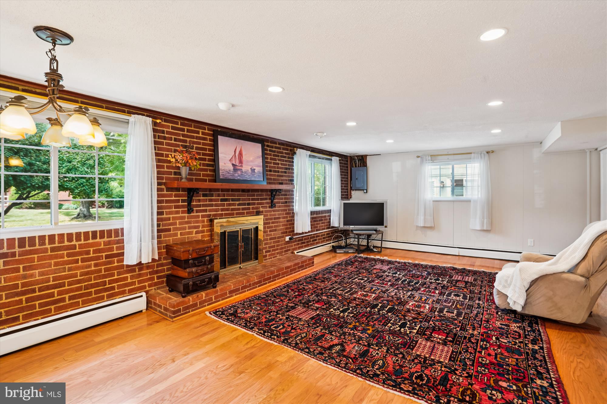 6216 Rockhurst Road Bethesda, MD 20817 - Photo 22 of 52 a living room with patio furniture and a fireplace