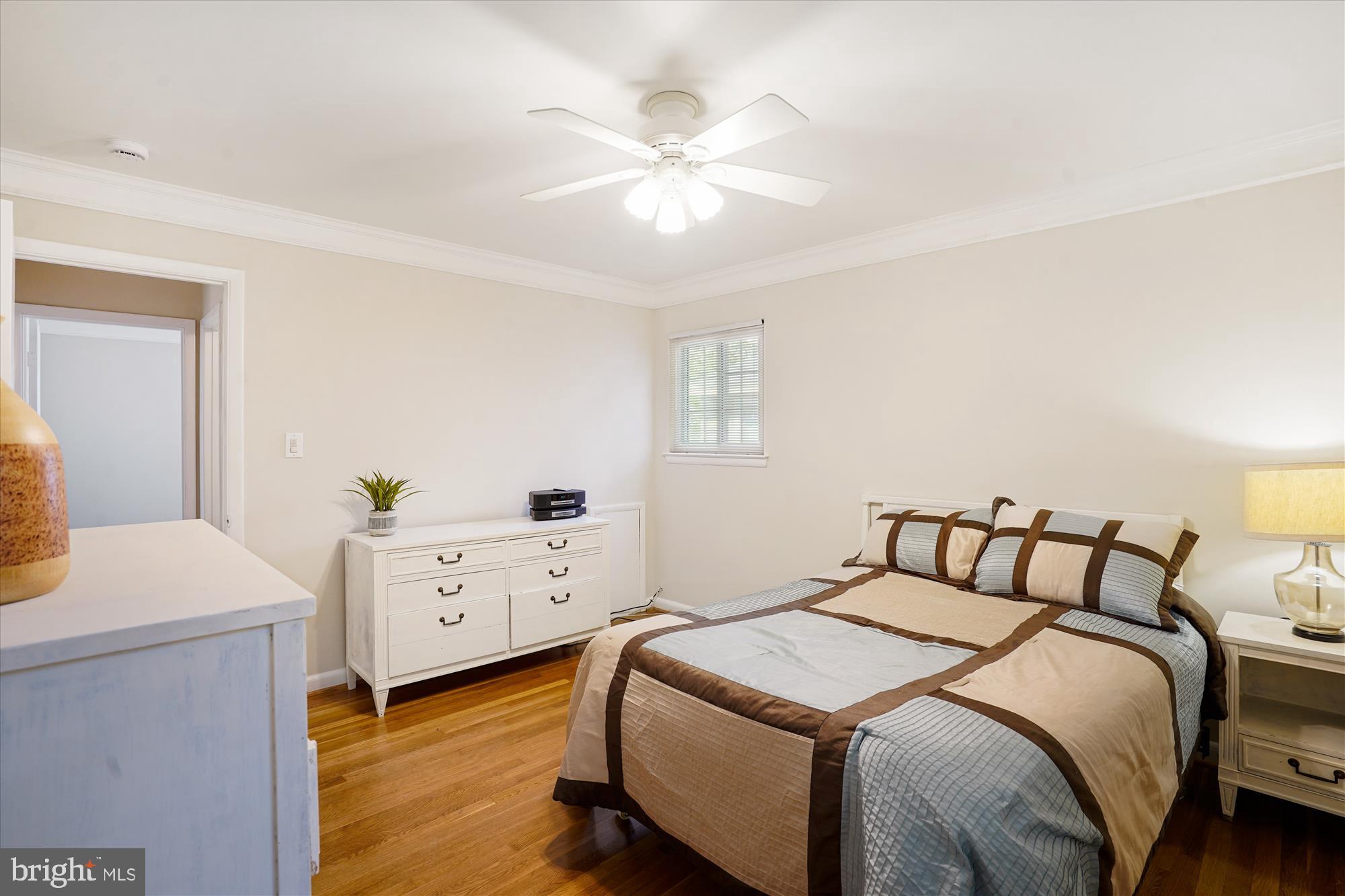 6216 Rockhurst Road Bethesda, MD 20817 - Photo 26 of 52 a bedroom with a bed and a chandelier