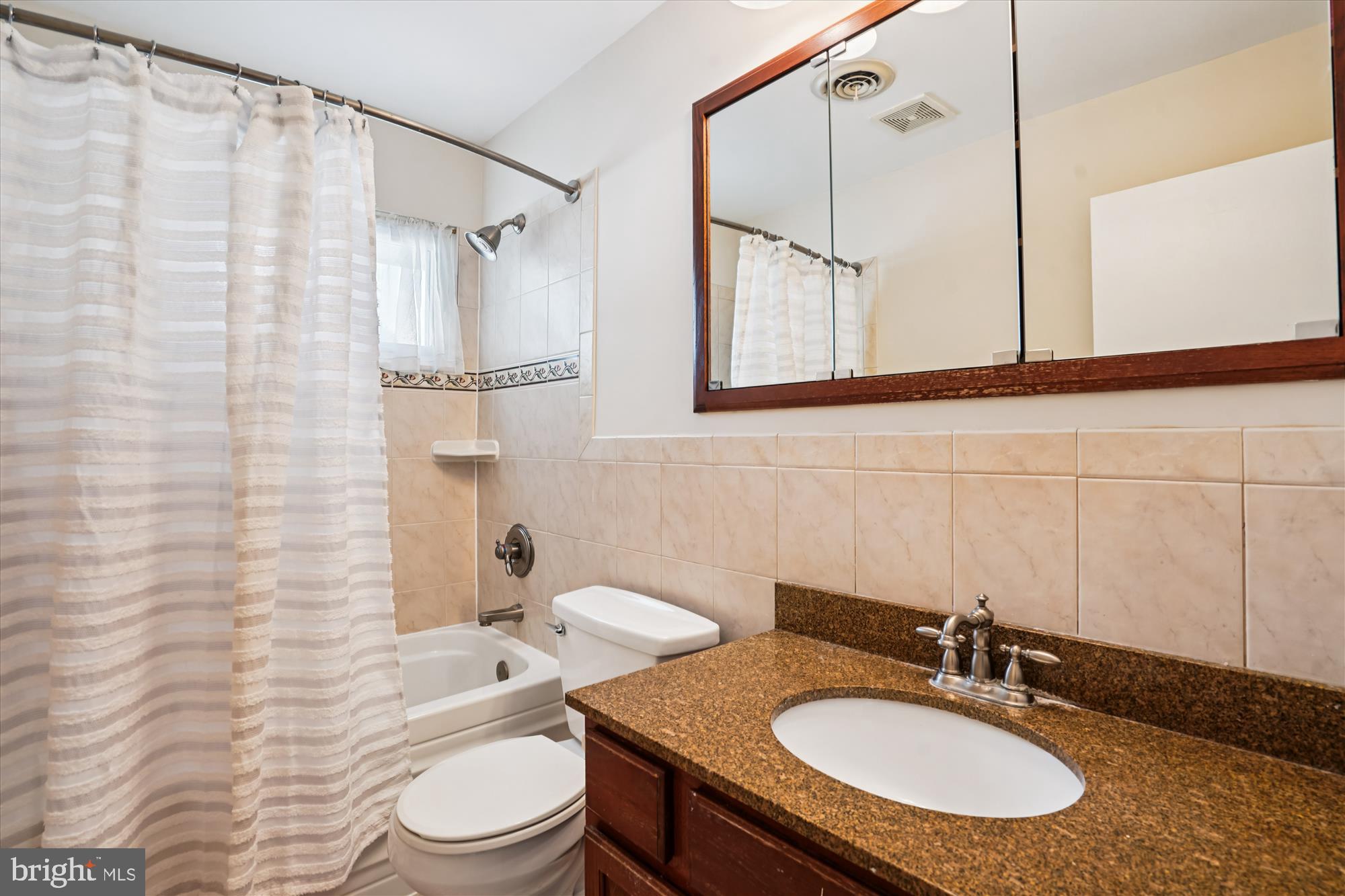 6216 Rockhurst Road Bethesda, MD 20817 - Photo 31 of 52 a bathroom with a sink toilet a mirror and shower