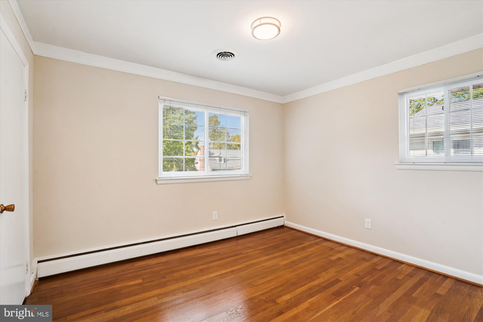 6216 Rockhurst Road Bethesda, MD 20817 - Photo 32 of 52 an empty room with wooden floor and windows