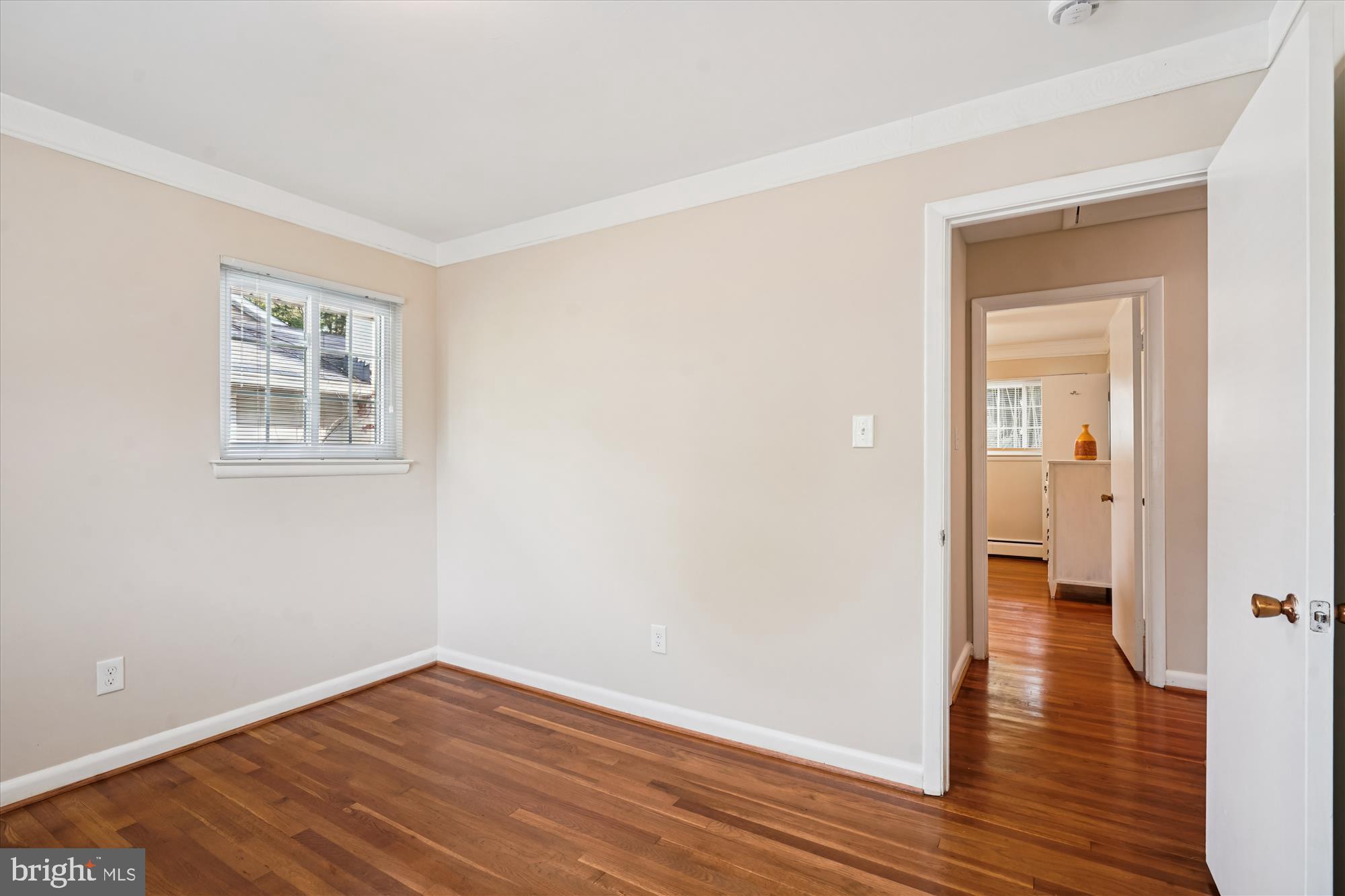 6216 Rockhurst Road Bethesda, MD 20817 - Photo 33 of 52 a view of an empty room with wooden floor and a window