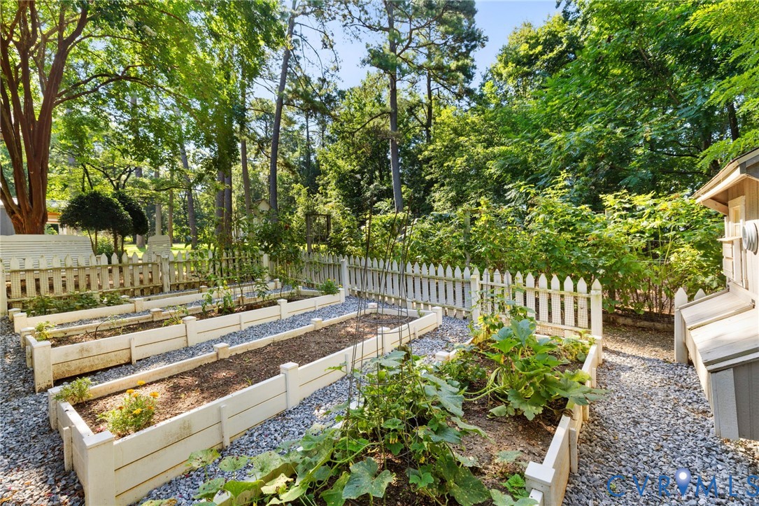 281 Echo Meadows Road Rockville, VA 23146 - Photo 38 of 49 a view of a yard with plants and a bench