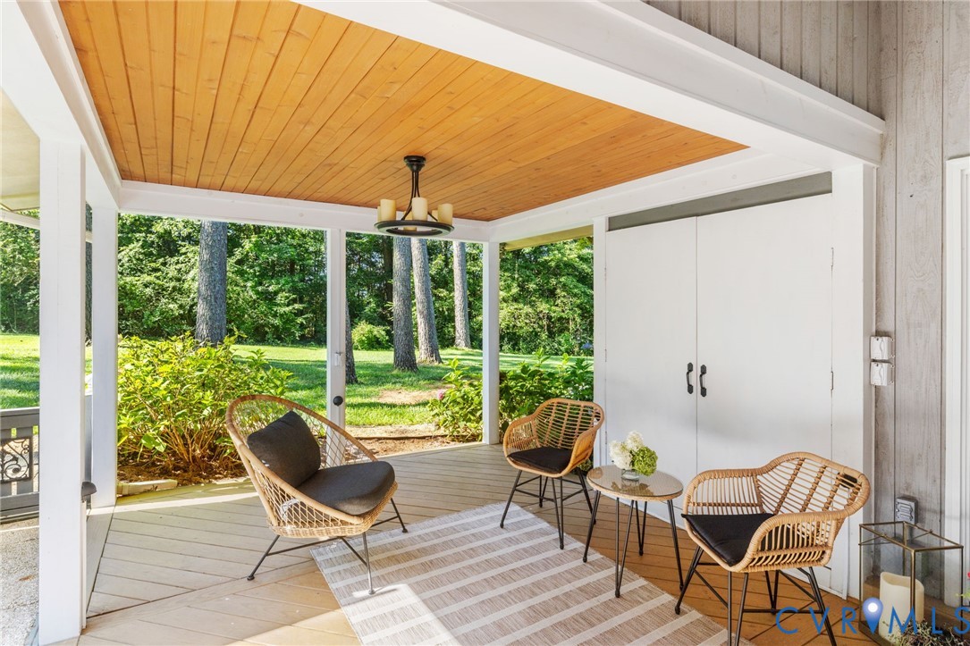 281 Echo Meadows Road Rockville, VA 23146 - Photo 45 of 49 a view of a patio with table and chairs and floor to ceiling window