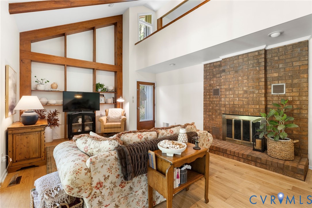 281 Echo Meadows Road Rockville, VA 23146 - Photo 10 of 49 a living room with furniture a fireplace and a floor to ceiling window