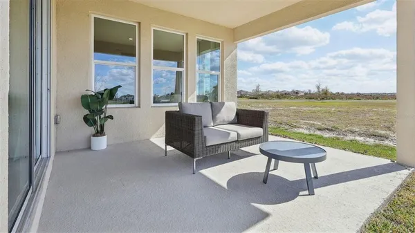 a living room with furniture and a floor to ceiling window