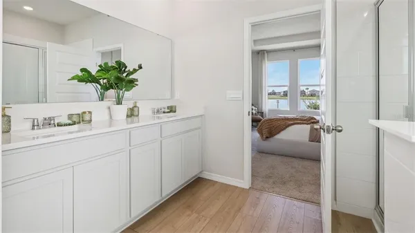 a en suite bathroom with a granite countertop sink and a mirror