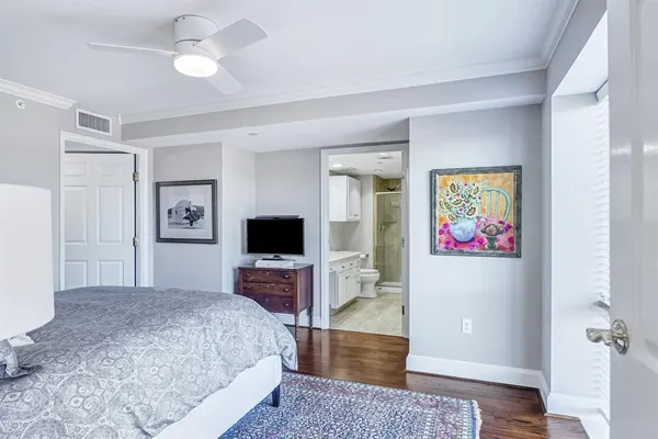 a bedroom with a bed and a television