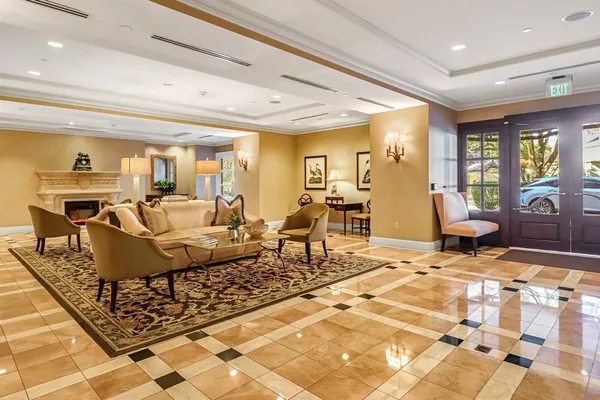 a living room with furniture and a dining table