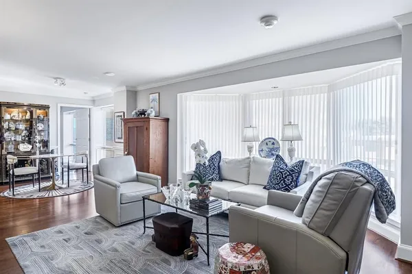 a living room with furniture rug and wooden floor