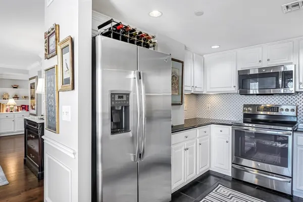 a kitchen with stainless steel appliances a refrigerator sink and cabinets