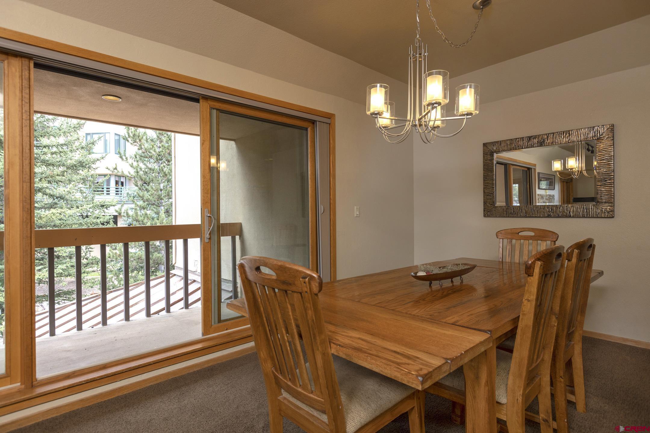 93 Needles Way, Unit 413 Durango, CO 81301 - Photo 14 of 31 a view of a dining room with furniture window and outside view