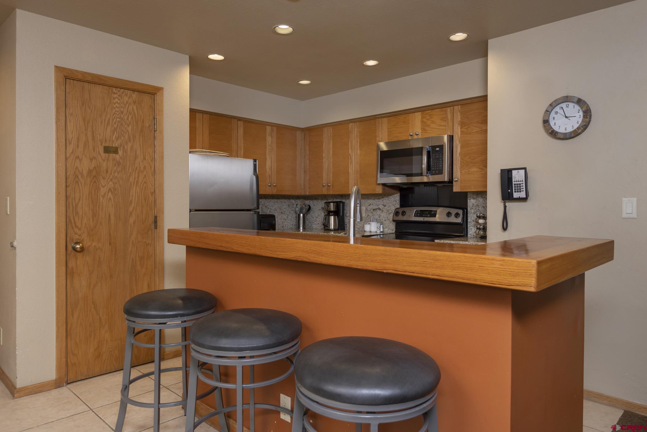 93 Needles Way, Unit 413 Durango, CO 81301 - Photo 15 of 31 a kitchen with stainless steel appliances a refrigerator a stove a sink and chairs