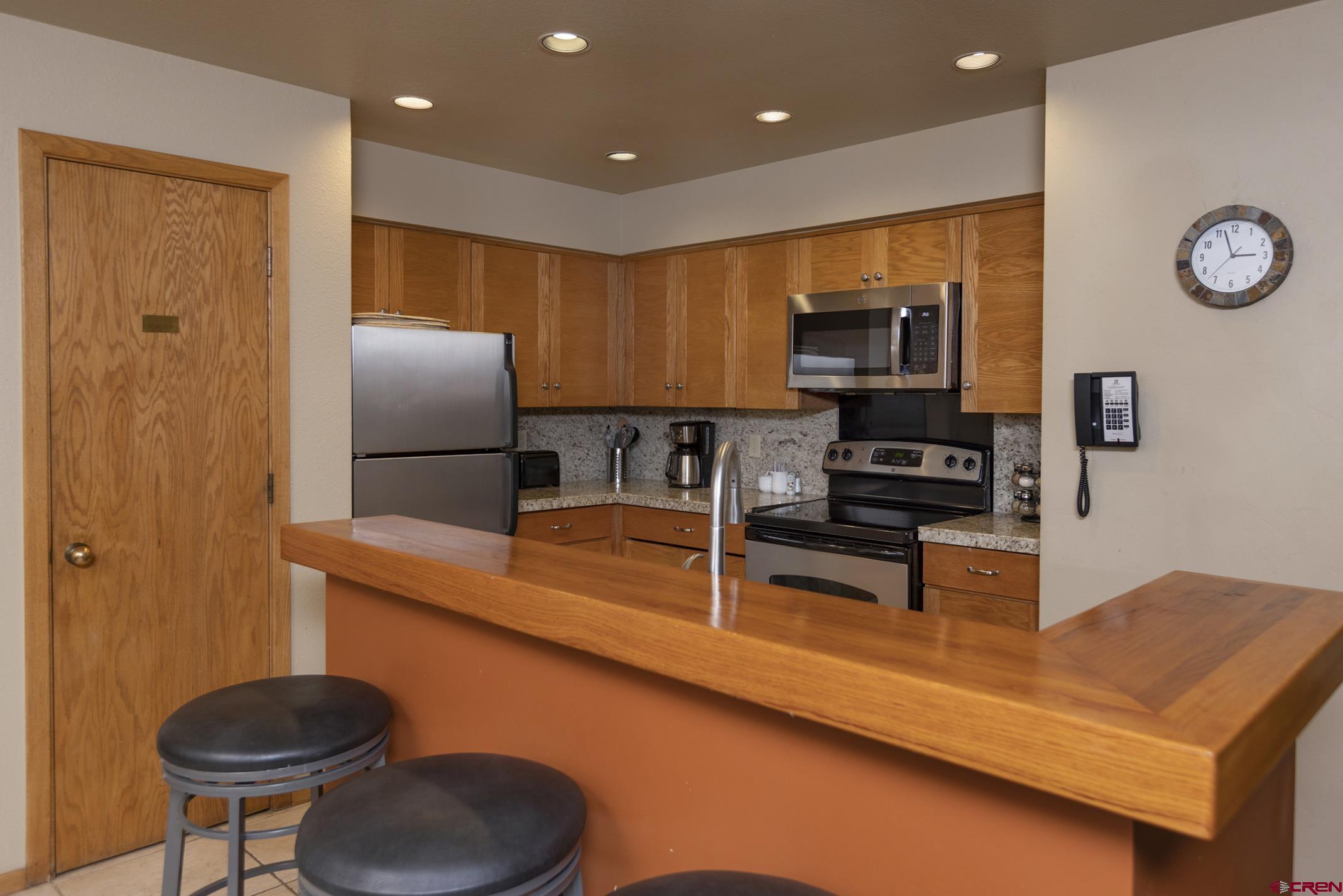 93 Needles Way, Unit 413 Durango, CO 81301 - Photo 16 of 31 a kitchen with stainless steel appliances granite countertop a sink refrigerator stove and microwave