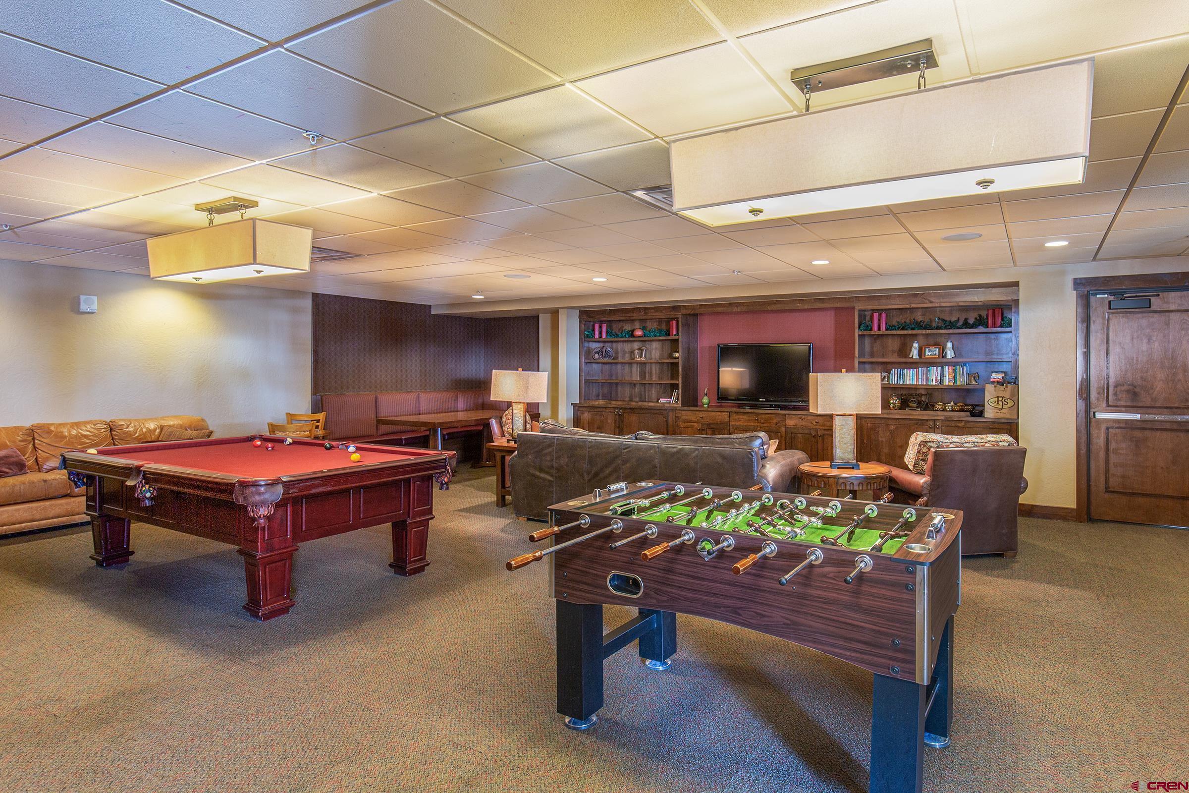 93 Needles Way, Unit 413 Durango, CO 81301 - Photo 29 of 31 a living room with furniture pool table and a fireplace