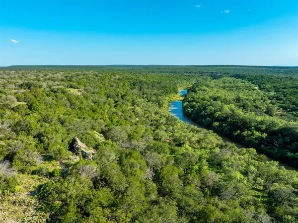 an aerial view of a houses with a yard