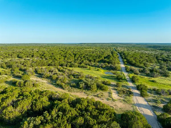 a view of a field with an ocean