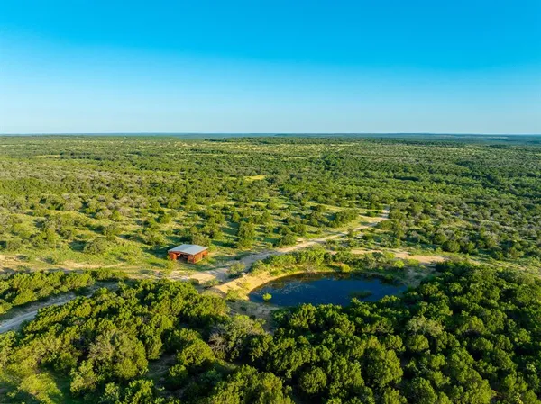 a view of a field with an ocean