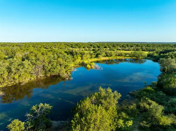 a view of a lake with a yard